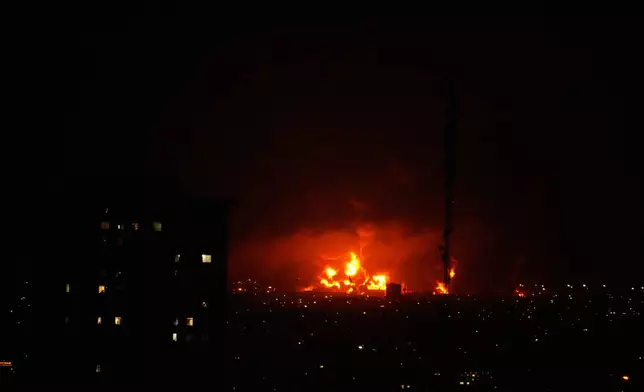 Flames rise from an oil storage facility south of the capital Tehran as strikes hit the city during the U.S.–Israeli military campaign, Iran, Saturday, March 7, 2026. (AP Photo/Vahid Salemi)