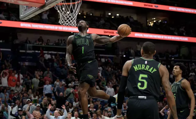 New Orleans Pelicans forward Zion Williamson (1) does a windmill dunk against the Toronto Raptors during the second half of an NBA basketball game in New Orleans, Wednesday, March 11, 2026. (AP Photo/Matthew Hinton)