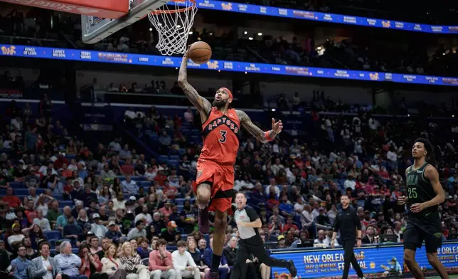 Toronto Raptors forward Brandon Ingram (3) dunks after breaking away with steal next to New Orleans Pelicans forward Trey Murphy III (25) during the first half of an NBA basketball game in New Orleans, Wednesday, March 11, 2026. (AP Photo/Matthew Hinton)