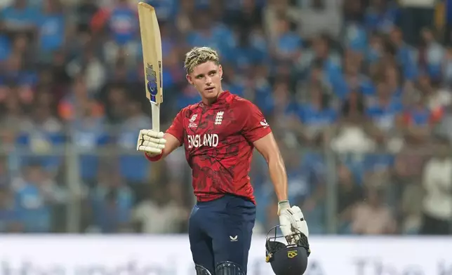England's Jacob Bethell celebrates after scoring a century during the T20 World Cup cricket semi-final match between India and England in Mumbai, India, Thursday, March 5, 2026. (AP Photo/Rafiq Maqbool)