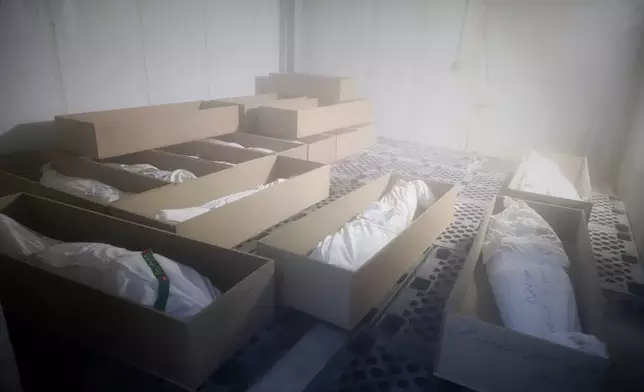 Coffins holding the bodies of mostly children sit in a room as they are prepared for the funeral of those killed in what Iranian officials said was an Israeli-U.S. strike Feb. 28 at a girls' elementary school in Minab, Iran, Tuesday, March 3, 2026. (Amirhossein Khorgooei/ISNA via AP)