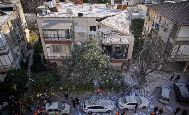 Officers from Israel's Home Front Command inspect a damaged apartment building after an Iranian missile strike in Ramat Gan, Israel, Tuesday, March 3, 2026. (AP Photo/Ohad Zwigenberg)