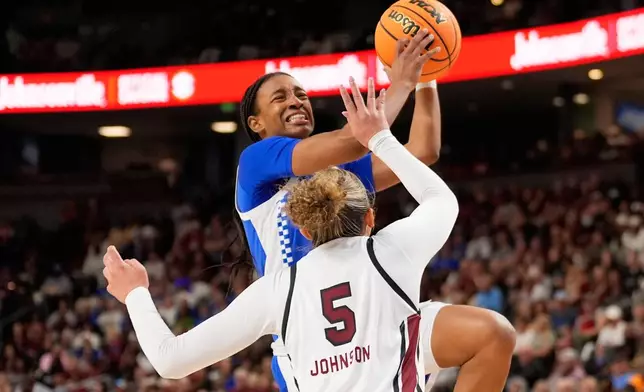 Kentucky guard Tonie Morgan shoots over South Carolina guard Tessa Johnson during first half of an NCAA college basketball game in the quarterfinals of the Southeastern Conference tournament, Friday, March 6, 2026, in Greenville, S.C. (AP Photo/Chris Carlson)