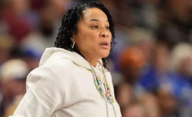 South Carolina head coach Dawn Staley watchers during first half of an NCAA college basketball game against Kentuck in the quarterfinals of the Southeastern Conference tournament, Friday, March 6, 2026, in Greenville, S.C. (AP Photo/Chris Carlson)