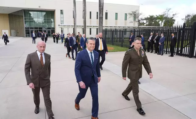 From left, White House deputy chief of staff Stephen Miller, Defense Secretary Pete Hegseth and Gen. Francis L. Donovan, Commander of the Southern Command, arrive at the inaugural Americas Counter Cartel Conference at U.S. Southern Command in Doral, Fla., Thursday, March 5, 2026. (AP Photo/Rebecca Blackwell)