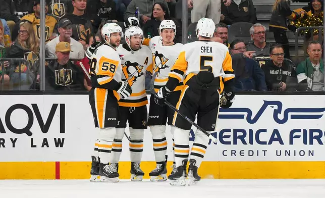 Pittsburgh Penguins right wing Rickard Rakell (67) celebrates his goal against the Vegas Golden Knights with teammates during the second period of an NHL hockey game Thursday, March 12, 2026, in Las Vegas. (AP Photo/Candice Ward)