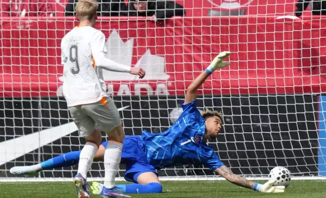 Iceland's Orri Steinn Oskarsson scores a goal past Canada goalkeeper Dayne St. Clair during an international friendly soccer match in Toronto, Saturday March 28, 2026. (Chris Young/The Canadian Press via AP)