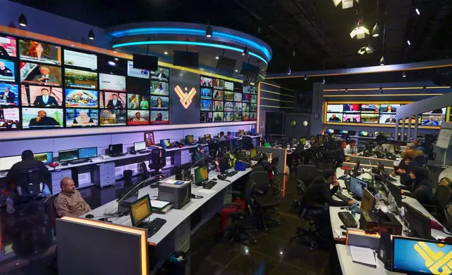 FILE - Employees work in the newsroom of Hezbollah's Al-Manar TV station in Dahiyeh, a southern suburb of Beirut, Lebanon, Thursday, Dec. 10, 2015. (AP Photo/Bilal Hussein, File)
