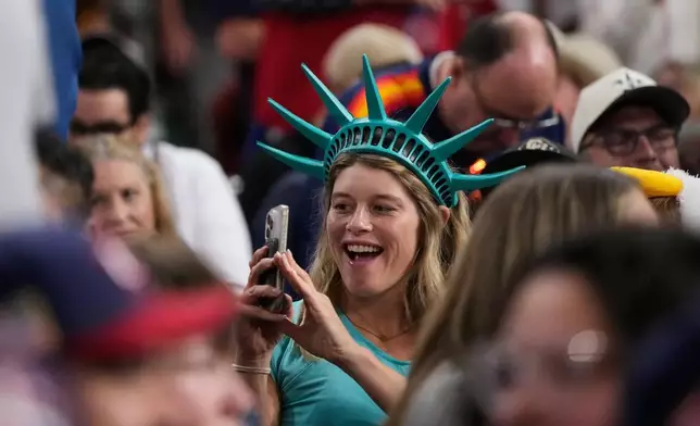 Fans cheer for the United States during the sixth inning of a World Baseball Classic quarterfinal game against Canada, Friday, March 13, 2026, in Houston. (AP Photo/David J. Phillip)