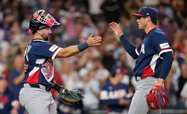 United States catcher Cal Raleigh, left, and pitcher Mason Miller, right, celebrate after their win over Canada in a World Baseball Classic quarterfinal game, Friday, March 13, 2026, in Houston. (AP Photo/David J. Phillip)