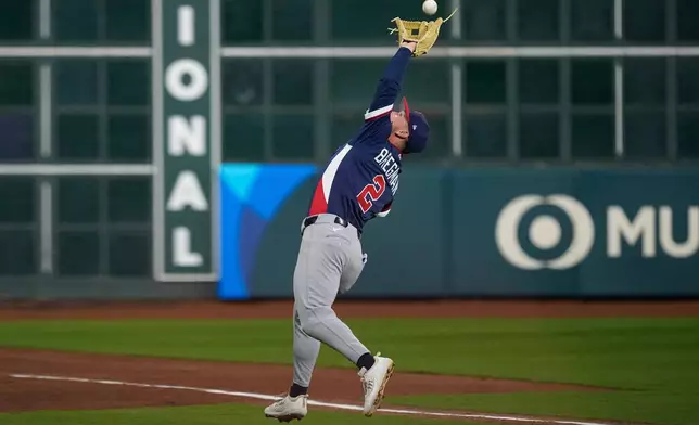 United States third baseman Alex Bregman (2) catches a pop fly by Canada first baseman Josh Naylor (12) during the first inning of a World Baseball Classic quarterfinal game, Friday, March 13, 2026, in Houston. (AP Photo/David J. Phillip)