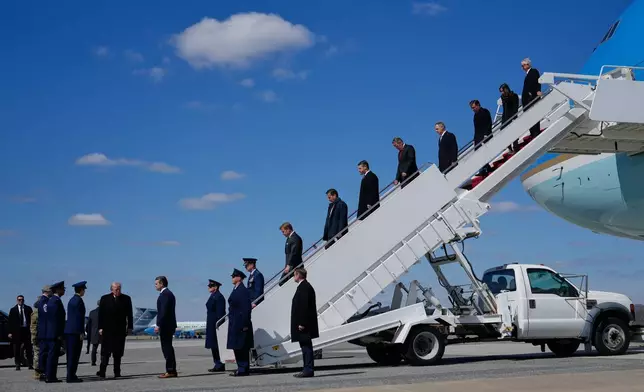 President Donald Trump arrives with Defense Secretary Pete Hegseth, Chairman of the Joint Chiefs of Staff Gen. Dan Caine and members of Congress, on Air Force One, Wednesday, March 18, 2026, at Dover Air Force Base, Del., to attend the casualty return for the six crew members of an Air Force refueling aircraft who died when their plane crashed in western Iraq while supporting operations against Iran. (AP Photo/Julia Demaree Nikhinson)
