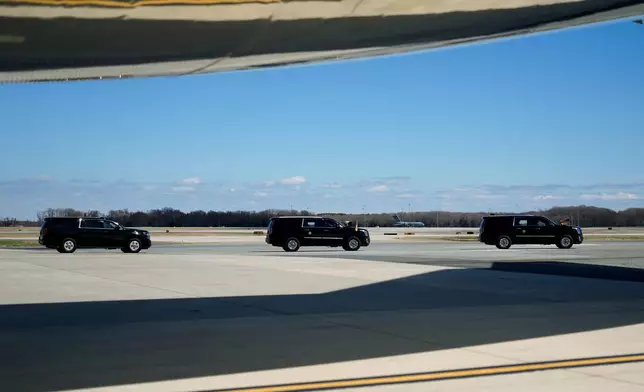 A motorcade drives President Donald Trump past Air Force One, Wednesday, March 18, 2026, at Dover Air Force Base, Del., to attend the casualty return for the six crew members of an Air Force refueling aircraft who died when their plane crashed in western Iraq while supporting operations against Iran. (AP Photo/Julia Demaree Nikhinson)