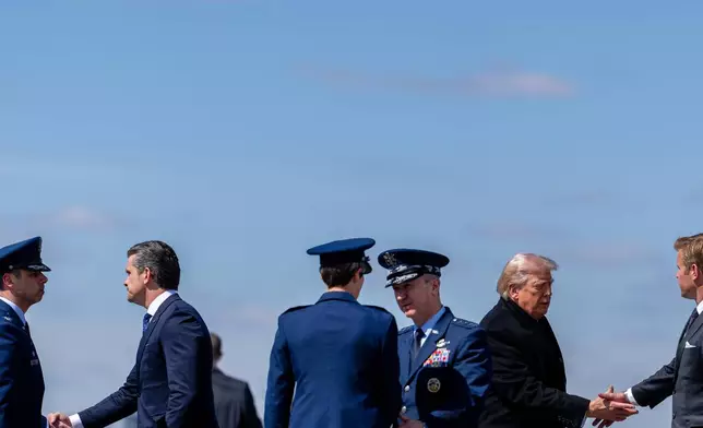 President Donald Trump arrives with Defense Secretary Pete Hegseth, second from left, and Chairman of the Joint Chiefs of Staff Gen. Dan Caine on Air Force One, Wednesday, March 18, 2026, at Dover Air Force Base, Del., to attend the casualty return for the six crew members of an Air Force refueling aircraft who died when their plane crashed in western Iraq while supporting operations against Iran. (AP Photo/Julia Demaree Nikhinson)