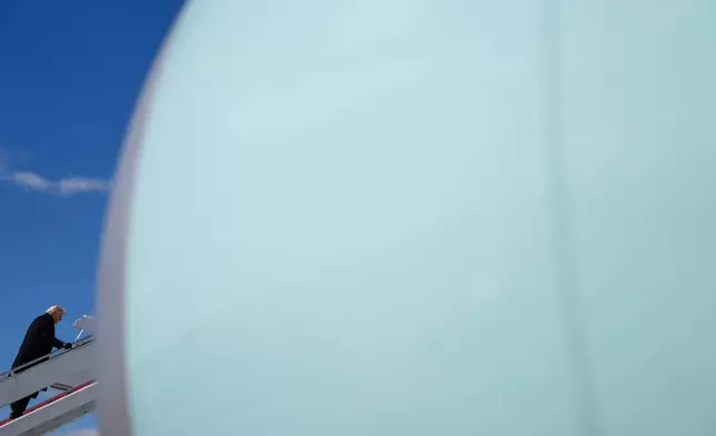 President Donald Trump boards Air Force One, Wednesday, March 18, 2026, at Dover Air Force Base, Del., after attending the casualty return for the six crew members of an Air Force refueling aircraft who died when their plane crashed in western Iraq while supporting operations against Iran. (AP Photo/Julia Demaree Nikhinson)