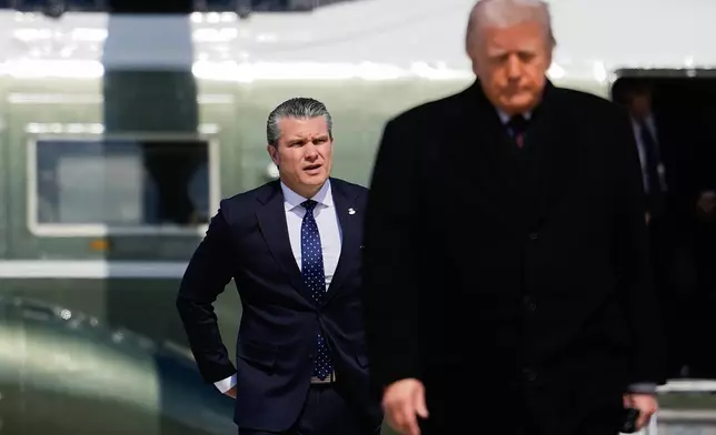 Defense Secretary Pete Hegseth follows President Donald Trump to board Air Force One, Wednesday, March 18, 2026, at Joint Base Andrews, Md. (AP Photo/Julia Demaree Nikhinson)