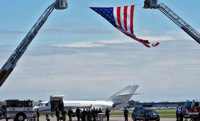 A military honor guard salutes as the remains of U.S. Army Reserve Maj. Cody Khork, a service member killed in the line of duty in the Middle East, arrives at the Lakeland Linder Airport Wednesday, March 18, 2026, in Lakeland, Fla. (AP Photo/Chris O'Meara)