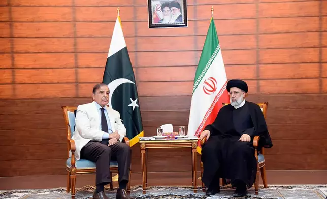 FILE - In this photo released by Pakistan Prime Minister Office, Pakistan's Prime Minister Shahbaz Sharif, left, and Iran's President Ebrahim Raisi meet during an inauguration of the Mand-Pishin border in Pishin, border of Pakistan-Iran, on May 18, 2023. (Pakistan Prime Minister Office via AP, File)