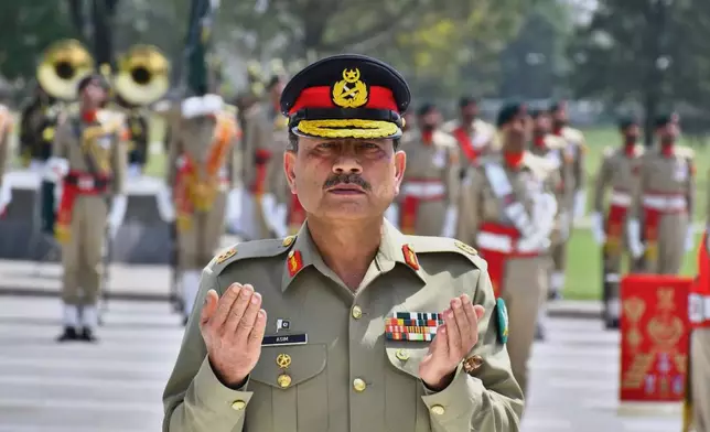 FILE - In this photo released by the Inter Services Public Relations, newly elevated Field Marshal General Asim Munir prays after laying wreath on the Martyrs monument during a special guard of honor ceremony at General Headquarters, in Rawalpindi, Pakistan, May 21, 2025. (Inter Services Public Relations via AP, File)
