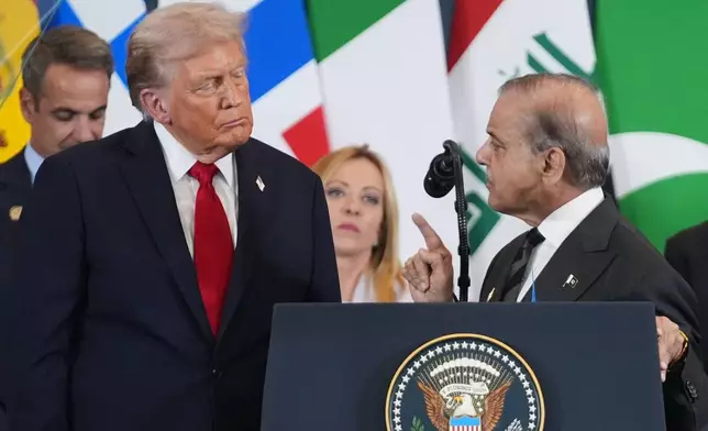 FILE - President Donald Trump, left, listens as Pakistan's Prime Minister Shehbaz Sharif speaks during a summit to support ending the more than two-year Israel-Hamas war in Gaza after a breakthrough ceasefire deal, on Oct. 13, 2025, in Sharm El Sheikh, Egypt. (AP Photo/Evan Vucci, File)