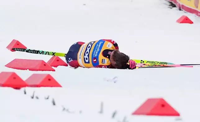 Norway's Johannes Hoesflot Klaebo lies on the snow after a fall during the World Cup sprint cross-country race in Drammen, Norway, Thursday March 12, 2026. (Lise Aserud/NTB Scanpix via AP)