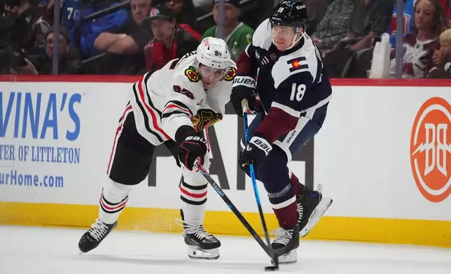 Chicago Blackhawks right wing Ilya Mikheyev, left, tries to block a pass by Colorado Avalanche center Jack Drury in the second period of an NHL hockey game Saturday, Feb. 28, 2026, in Denver. (AP Photo/David Zalubowski)