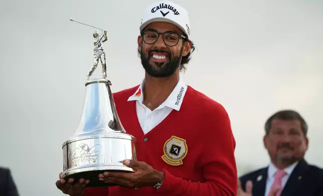 Akshay Bhatia holds the championship trophy after winning the Arnold Palmer Invitational at Bay Hill golf tournament Sunday, March 8, 2026, in Orlando, Fla. (AP Photo/Matt Slocum)