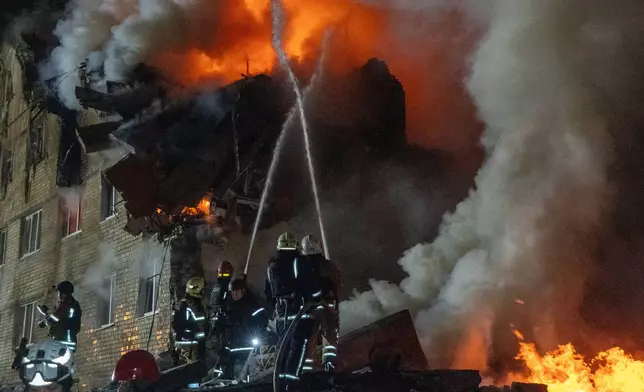 Firefighters battle a fire in an story apartment building following a Russian missile attack in Kharkiv, Ukraine, Saturday, March 7, 2026. (AP Photo/Andrii Marienko)