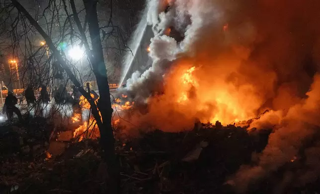 Firefighters put out the fire in an multi-storey apartment building following a Russian missile attack in Kharkiv, Ukraine, Saturday, March 7, 2026. (AP Photo/Andrii Marienko)