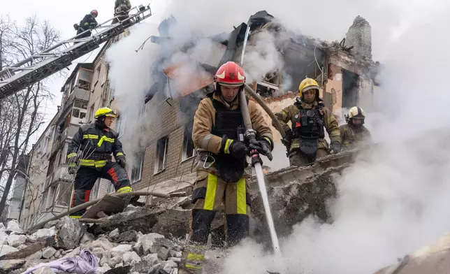 Firefighters put out the fire in the ruins of an apartment building following Russia's missile attack in Kharkiv, Ukraine, Saturday, March 7, 2026. (AP Photo/Andrii Marienko)