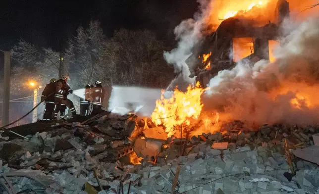 Firefighters put out the fire in an multi-storey apartment building following a Russian missile attack in Kharkiv, Ukraine, Saturday, March 7, 2026. (AP Photo/Andrii Marienko)