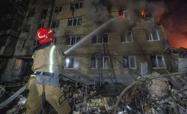 Firefighters put out the fire in an multi-storey apartment building following a Russian missile attack in Kharkiv, Ukraine, Saturday, March 7, 2026. (AP Photo/Andrii Marienko)