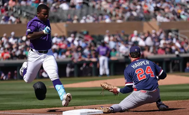 United States first baseman Bryce Harper (24) makes a catch at first base to get Colorado Rockies' Adael Amador, left, out during the first inning of an exhibition baseball game Wednesday, March 4, 2026, in Scottsdale, Ariz. (AP Photo/Ross D. Franklin)