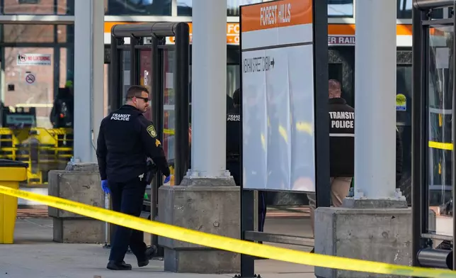 Law enforcement officials work a crime scene at the Forest Hills train station in the Jamaica Plain neighborhood, Friday, March 20, 2026, in Boston. (AP Photo/Charles Krupa)