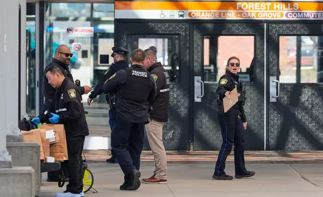 Law enforcement officials work a crime scene at the Forest Hills train station in the Jamaica Plain neighborhood, Friday, March 20, 2026, in Boston. (AP Photo/Charles Krupa)