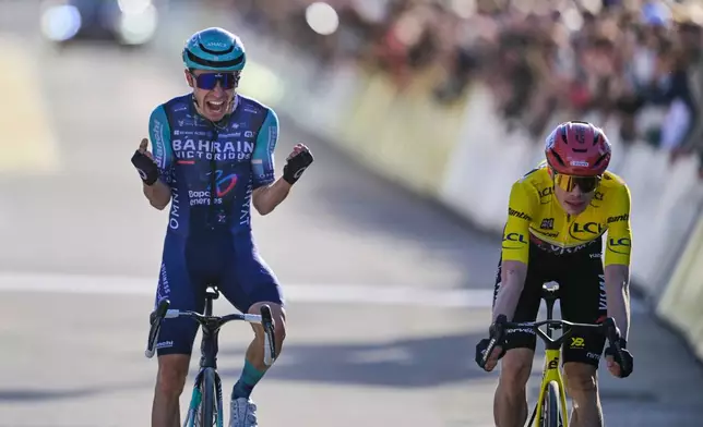 Lenny Martinez of France, left, celebrates as he crosses the finish line ahead of Jonas Vingegaard of Denmark, wearing the overall leader's yellow jersey, to win the last stage of the Paris Nice cycling race with start and finish in Nice, France, Sunday, March 15, 2026. (AP Photo/Philippe Magoni)