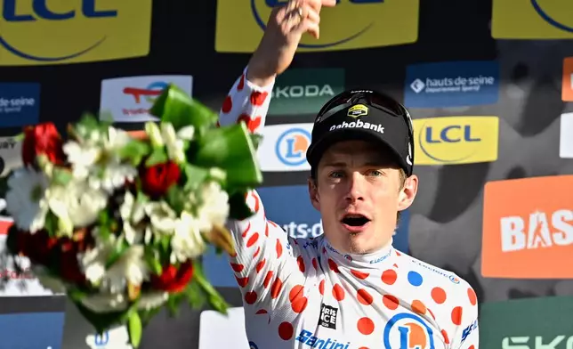 Overall winner Jonas Vingegaard of Denmark also took the best climber's dotted jersey after the last stage of the Paris Nice cycling race with start and finish in Nice, France, Sunday, March 15, 2026. (AP Photo/Philippe Magoni)