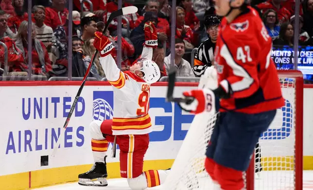 Calgary Flames right wing Matvei Gridin, left, celebrates his goal during the second period of an NHL hockey game against the Washington Capitals, Monday, March 9, 2026, in Washington. (AP Photo/Nick Wass)