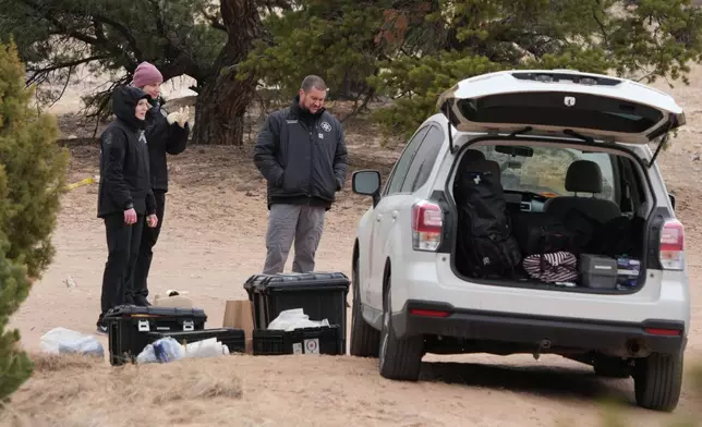 Police and investigators conduct an investigation at Cocks Comb trailhead where two woman were killed Wednesday, on Thursday, March 5, 2026, outside Teasdale, Utah. (AP Photo/George Frey)