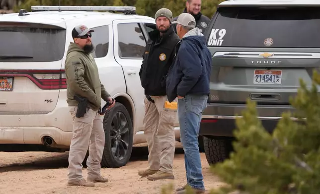 Authorities conduct an investigation Thursday, March 5, 2026, into the deaths of two women a day earlier on a trail just west of Capitol Reef National Park near Teasdale, Utah. (AP Photo/George Frey)