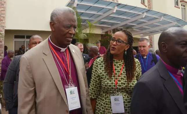Rwanda Archbishop Revd Dr. Laurent Mbanda, chairman of the Global Fellowship of Confessing Anglicans, or Gafcon, left, and his wife Chantel Mbanda, leave after attending a religious service on the sidelines of a meeting by the Anglican Communion in Abuja, Nigeria, Wednesday, March 4, 2026. (AP Photo/Olamikan Gbemiga)