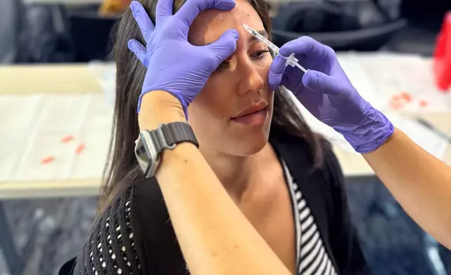 A MySpaLive student performs a supervised neurotoxin injection on a live model during hands-on clinical training, emphasizing safety, technique, and real-world experience.