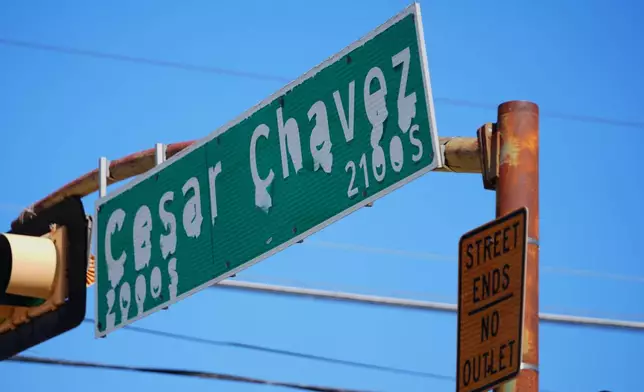 A worn sign identifies Cesar Chavez Boulevard in Dallas, Thursday, March 19, 2026. (AP Photo/Julio Cortez)