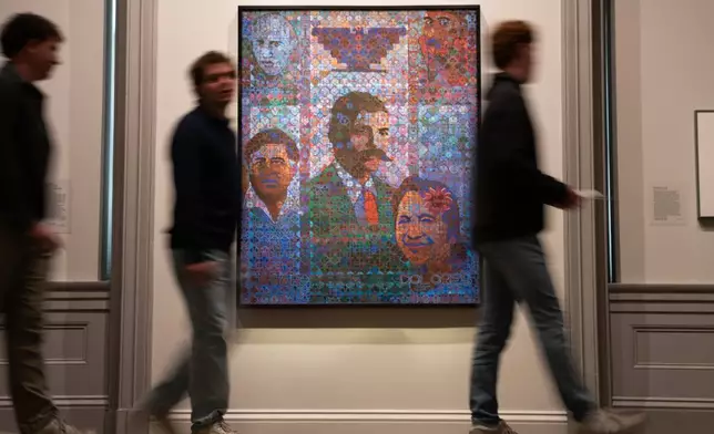 Museum attendees walk past a painting of individuals including César Chavez at the National Portrait Gallery on Thursday, March 19, 2026, in Washington. (AP Photo/Allison Robbert)