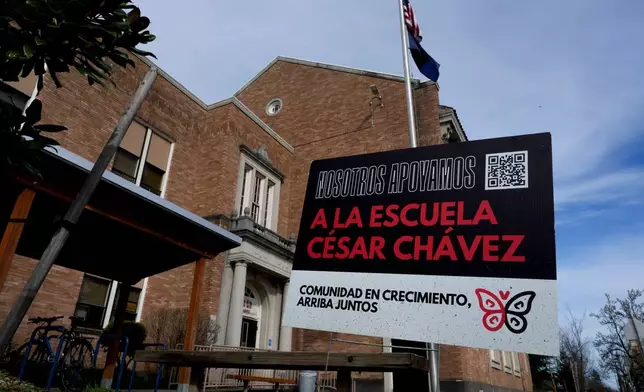 A sign is seen outside Cesar Chavez School on Wednesday, March 18, 2026, in Portland, Ore. (AP Photo/Jenny Kane)
