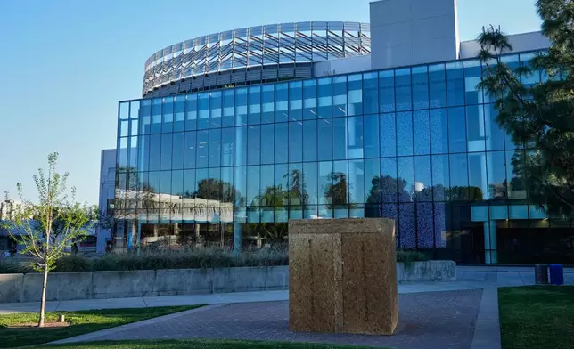 Plywood panels encapsulate a statue of César Chavez at California State University, Fresno in Fresno, Calif., Wednesday, March 18, 2026. (AP Photo/Godofredo A. Vásquez)