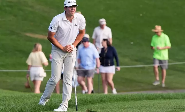 Michael Thorbjornsen watches his drive from the rough of the 18th fairway during the third round of The Players Championship golf tournament Saturday, March 14, 2026, in Ponte Vedra Beach, Fla. (AP Photo/Gerald Herbert)