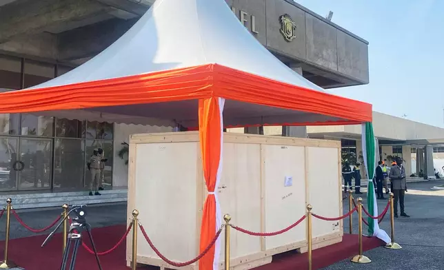 The crate containing a looted sacred talking drum is seen after it was returned to Abidjan, Ivory Coast, Friday, March 13, 2026. (AP Photo/Marine Jeannin)