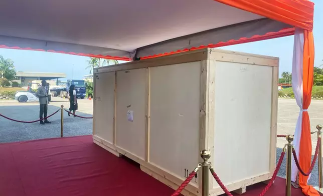 The crate containing a looted sacred talking drum is seen after it was returned to Abidjan, Ivory Coast, Friday, March 13, 2026. (AP Photo/Marine Jeannin)