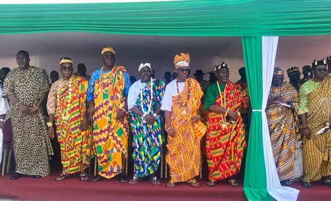 Traditional leaders stand during the return of a looted sacred talking drum in Abidjan, Ivory Coast, Friday, March 13, 2026. (AP Photo/Marine Jeannin)
